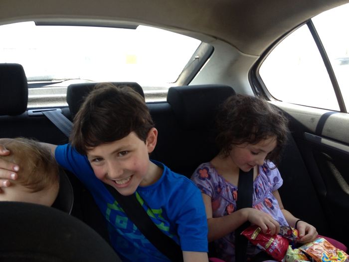 Two children in the back of a car