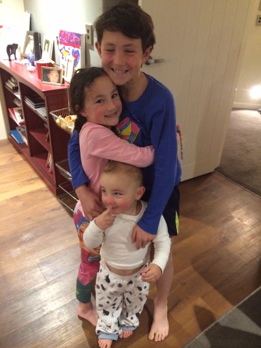 Children hugging in a hallway