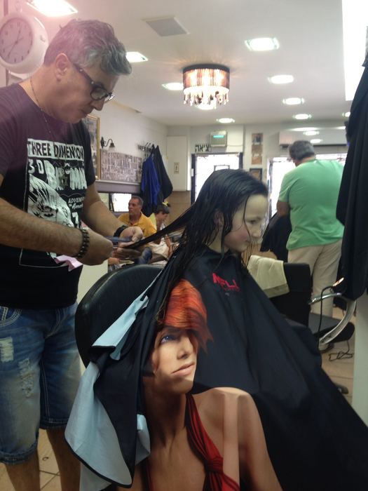 A hairdresser cutting a child's hair