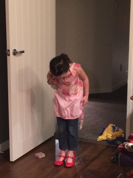 Girl standing in a hallway doorway