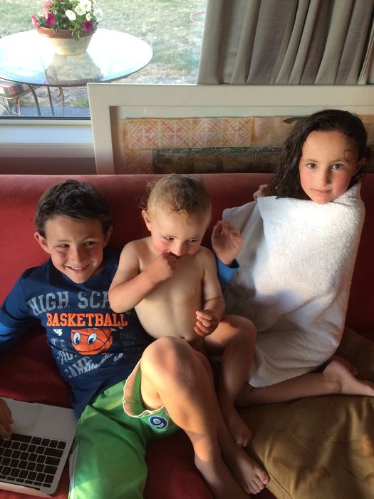 Three children on a couch together