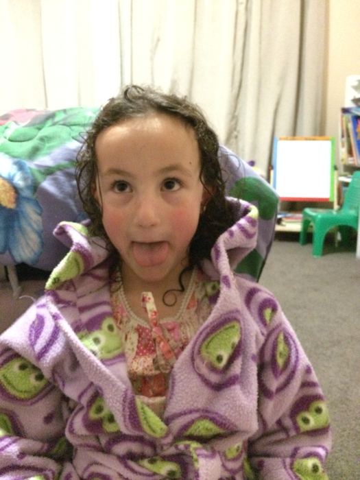 Girl in a dressing gown pulling a face