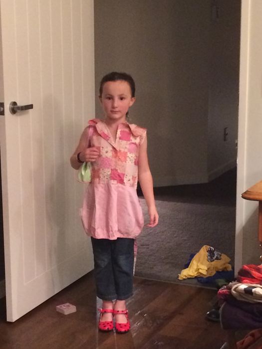 Girl standing in a doorway in a pink top