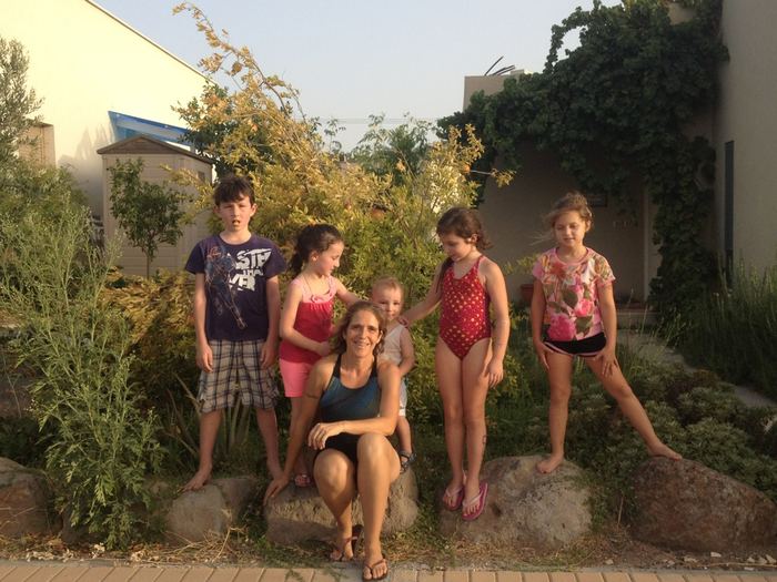 Family posing together outdoors at dusk