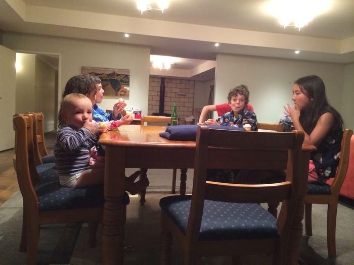 Children around a dining table in a hotel room