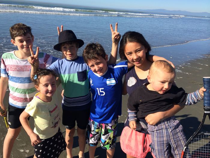 Group of children posing on the beach