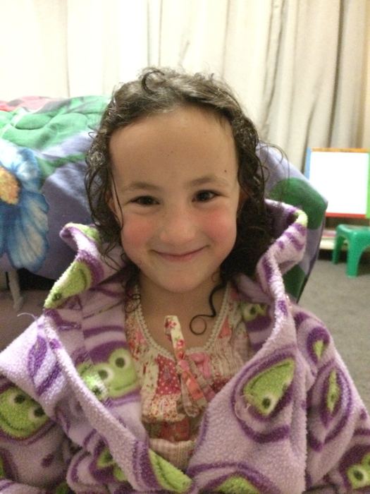 Girl in a patterned dressing gown, smiling