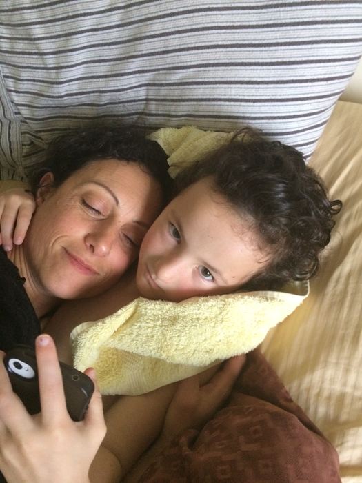 A mother and daughter resting head to head
