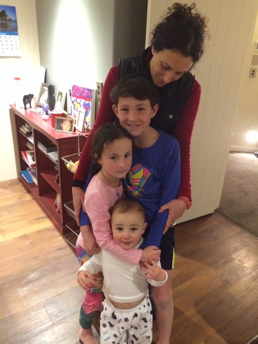 An adult and three children in a living room