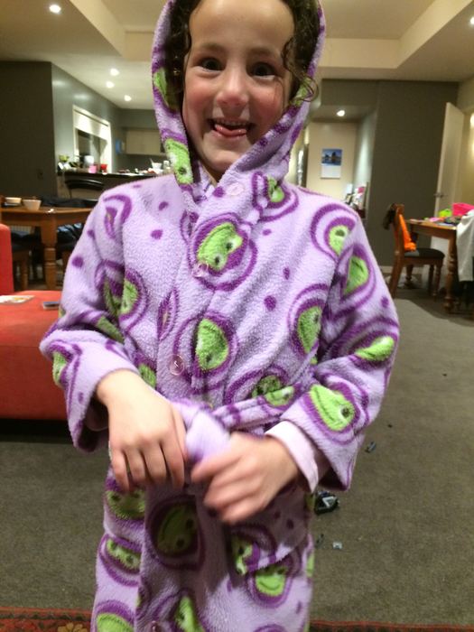 Girl in a dressing gown standing in a hotel room