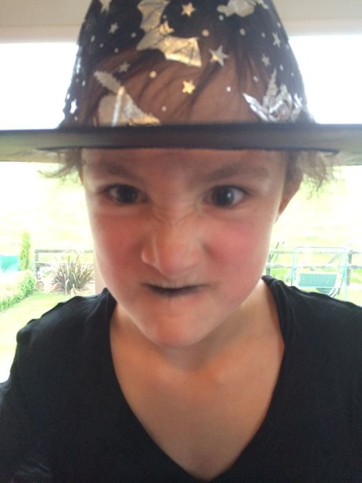 Close-up of a girl wearing a decorated witch hat